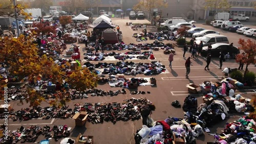 Aerial shot, flyover of evacuees and relief workers at parking lot distribution center for Camp Fire victims in California photo