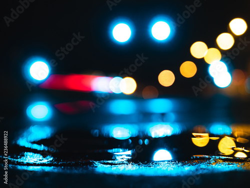 Wet city streets at night with bokeh in background