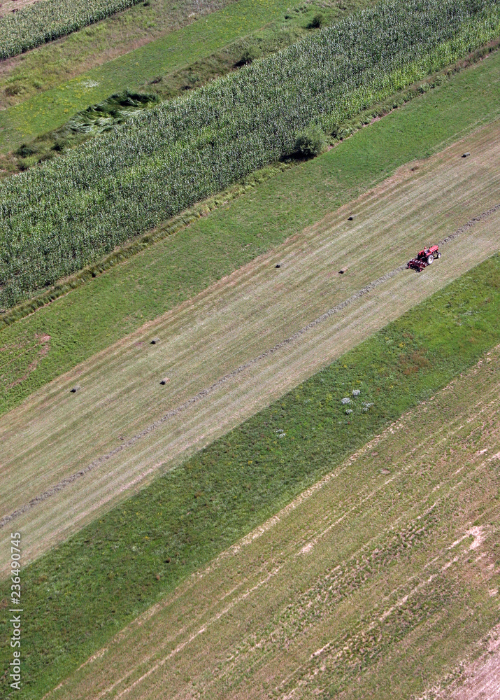 An aerial view of tractor working in a field in Sisljavic Croatia
