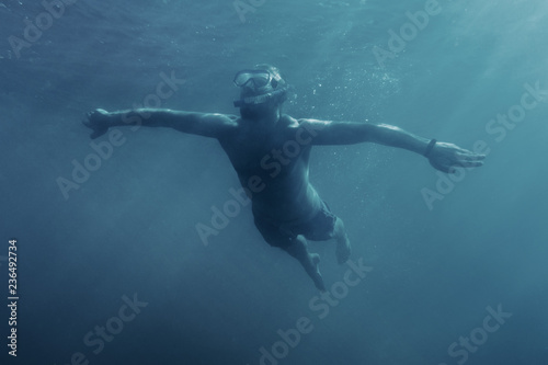 Happy man swimming underwater. © Alex Photo