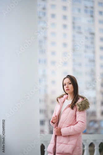 Free Download Beautiful young girl in white sweater and pink jacket walking in the Park. - GFXLoad