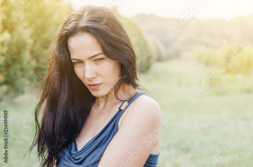 Close-up portrait charming brunette woman on natural background. Sexuality. Women Health.