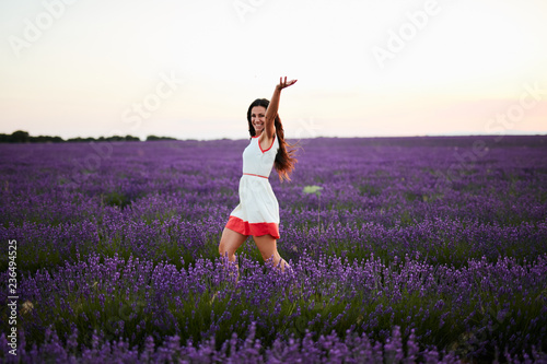 Wallpaper Mural Young woman running between violet lavender field Torontodigital.ca