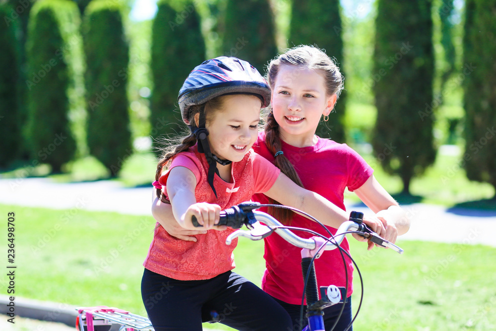 fun children ride a bike. Smiling kids summer vacation fun children ride a bike. Smiling kids summer vacation