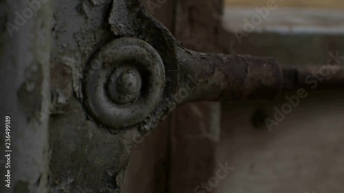 Opening and closing the rusty gate. Closeup of the gate axels.