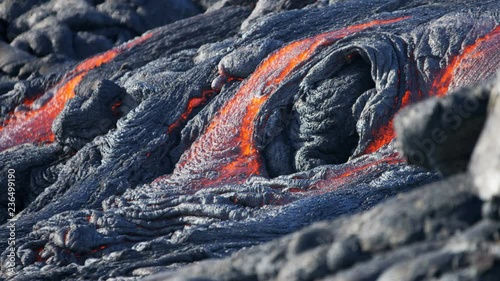 Volcanic red hot lava pouring into the Pacific ocean from Kilauea seen before dawn Hawaii USA  photo