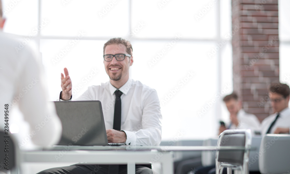 employee talking with a colleague in the workplace in the office employee talking with a colleague in the workplace in the office