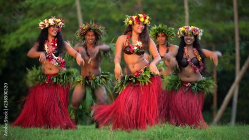 Young males and females in a group of Tahitian hula dancers performing outdoor barefoot in traditional costume Tahiti French Polynesia South Pacific photo