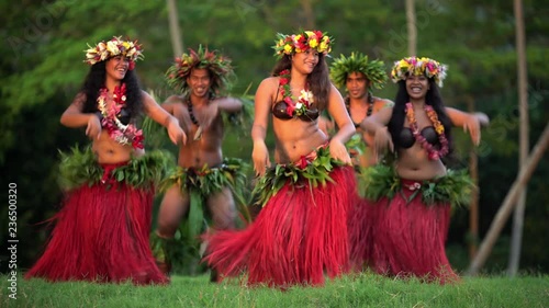 Young males and females in a group of Tahitian hula dancers performing outdoor barefoot in traditional costume Tahiti French Polynesia South Pacific