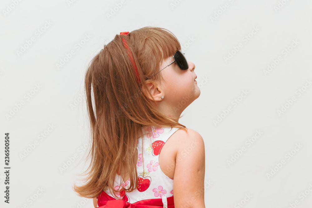 child in profile and dark glasses looking up, white background child in profile and dark glasses looking up, white background