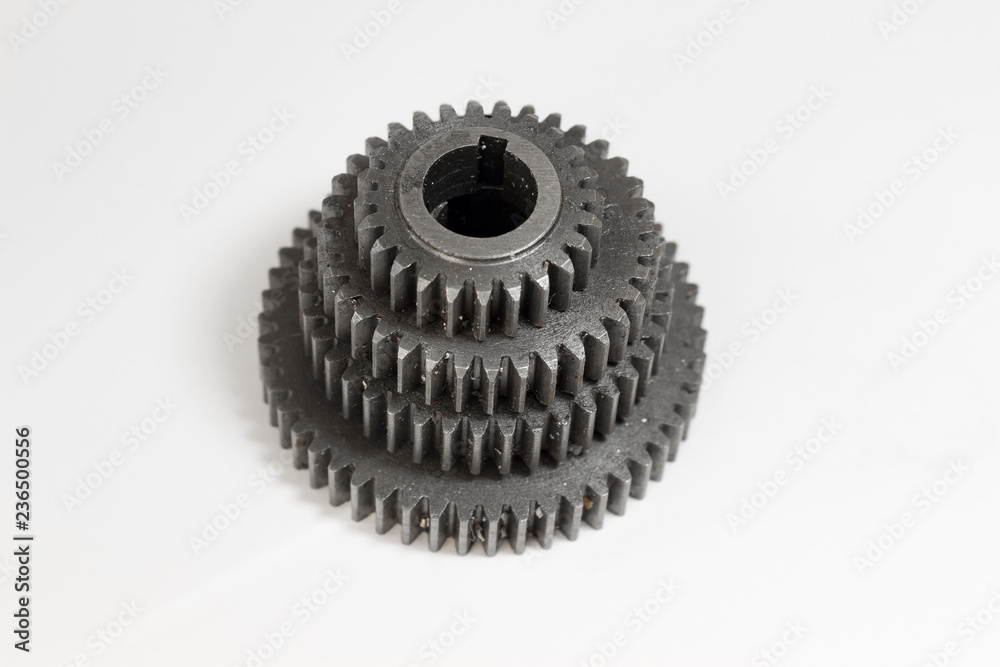 Metal gears wheels from large to small on white background . Repair parts, cogwheels, screw-wheels Metal gears wheels from large to small on white background . Repair parts, cogwheels, screw-wheels