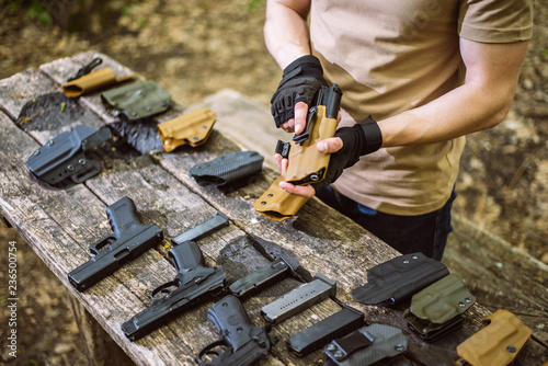 Photos guy in the woods tests his weapons for shooting sports