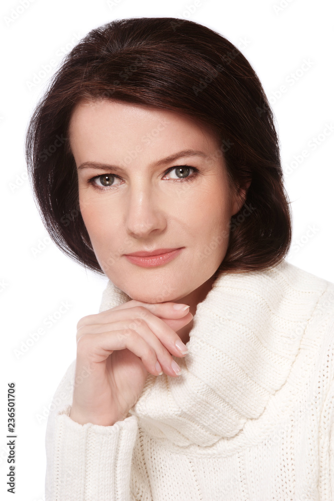 Portrait of attractive smiling mature woman in white pullover Portrait of attractive smiling mature woman in white pullover