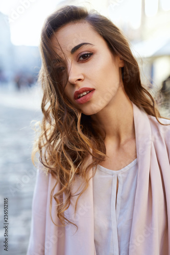 sensual portrait of a beautiful woman with long hair. sensual and sexy elegant woman posing outdoors on the street