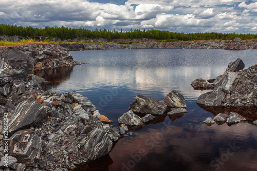 summer landscape of artificial lake in abandoned former marble stone mine, Karelia, Russia
