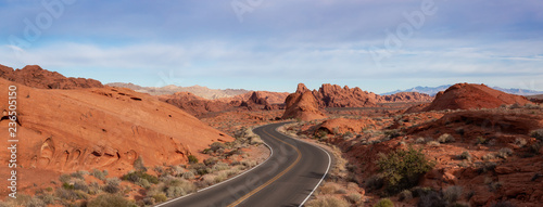 Scenic panoramic view on the road in the desert during a cloudy and sunny day. Taken in Valley of Fire State Park, Nevada, United States.