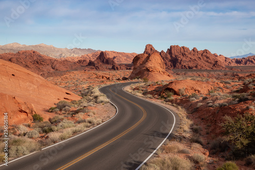 Scenic view on the road in the desert during a cloudy and sunny day. Taken in Valley of Fire State Park, Nevada, United States.