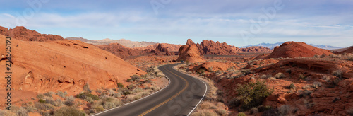 Scenic panoramic view on the road in the desert during a cloudy and sunny day. Taken in Valley of Fire State Park, Nevada, United States.