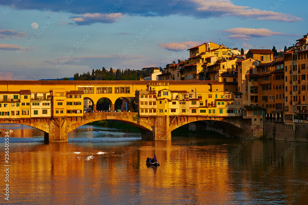 View of medieval stone bridge Ponte Vecchio and the Arno River in Florence, Tuscany, Italy. Florence is a popular tourist destination of Europe.
