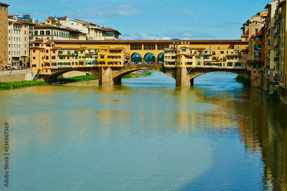 View of medieval stone bridge Ponte Vecchio and the Arno River in Florence, Tuscany, Italy. Florence is a popular tourist destination of Europe.