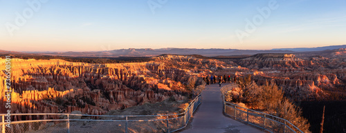 Bryce Canyon National Park, Utah, United States - November 13, 2018: Group of photographers are taking pictures of the beautiful landscape during a vibrant sunrise.
