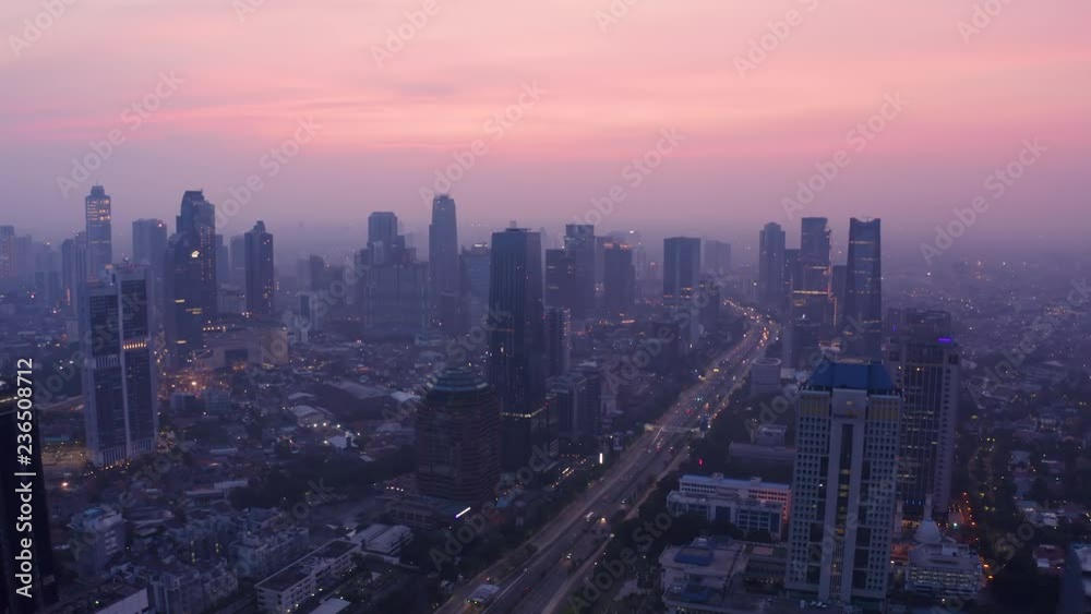 JAKARTA, Indonesia - November 26, 2018: Beautiful aerial scenery of Jakarta skyline at dawn with highway traffic and skyscrapers view. Shot in 4k resolution JAKARTA, Indonesia - November 26, 2018: Beautiful aerial scenery of Jakarta skyline at dawn with highway traffic and skyscrapers view. Shot in 4k resolution