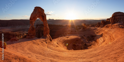 Beautiful landscape of the unique sandstone rock formation in the desert during a sunny sunset. Taken in Arches National Park, Moab, Utah, United States.
