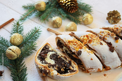 Poppy seed cake surrounded by spruce branches and gilded nuts