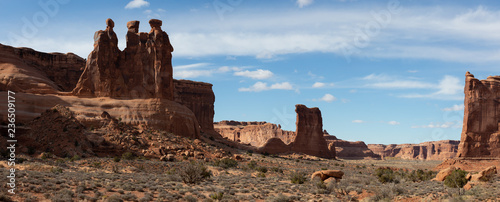 Panoramic Landscape view of beautiful red rock canyon formations during a vibrant sunny day. Taken in Arches National Park, located near Moab, Utah, United States.