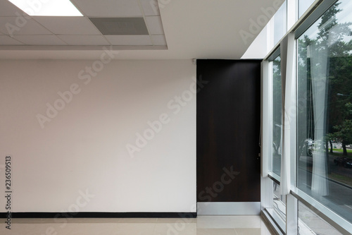 Interior of modern office with large window and wooden door, new space with reflections, latin america.