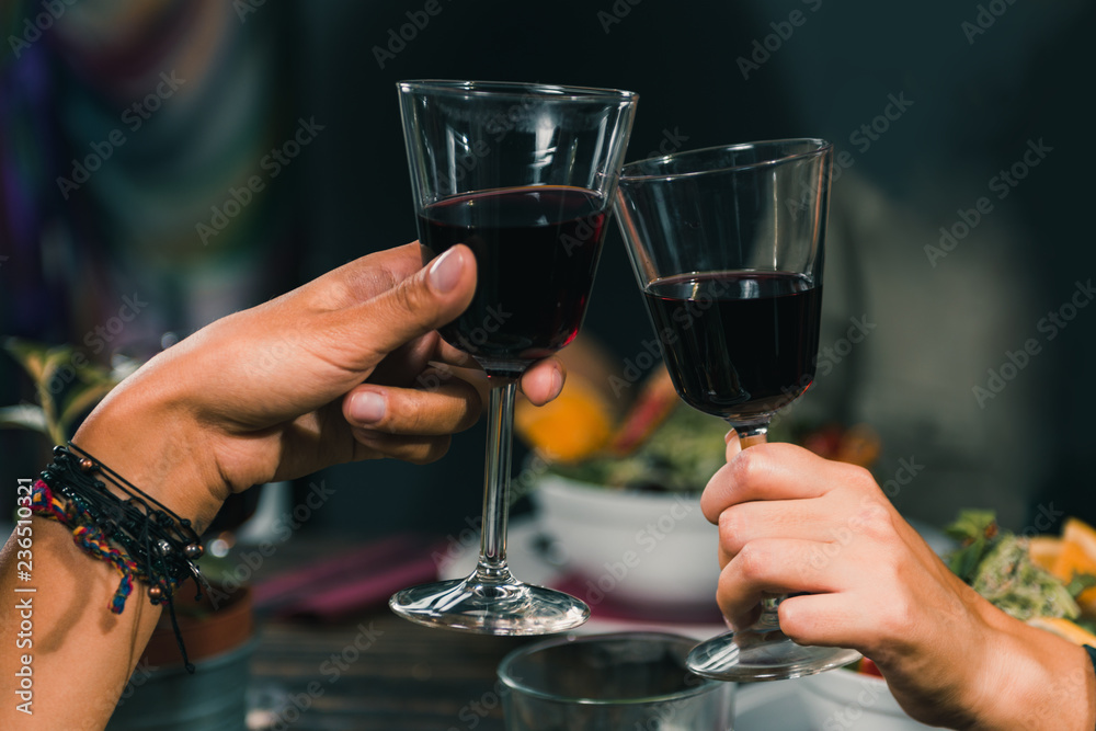 Drinking Red Wine. Young Women Toasting With Red Wine