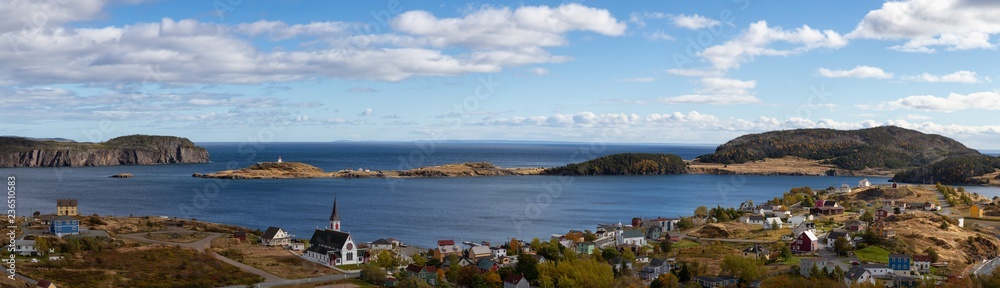 Aerial panoramic view of a small town on the Atlantic Ocean Coast during a sunny day. Taken in Trinity, Newfoundland and Labrador, Canada.