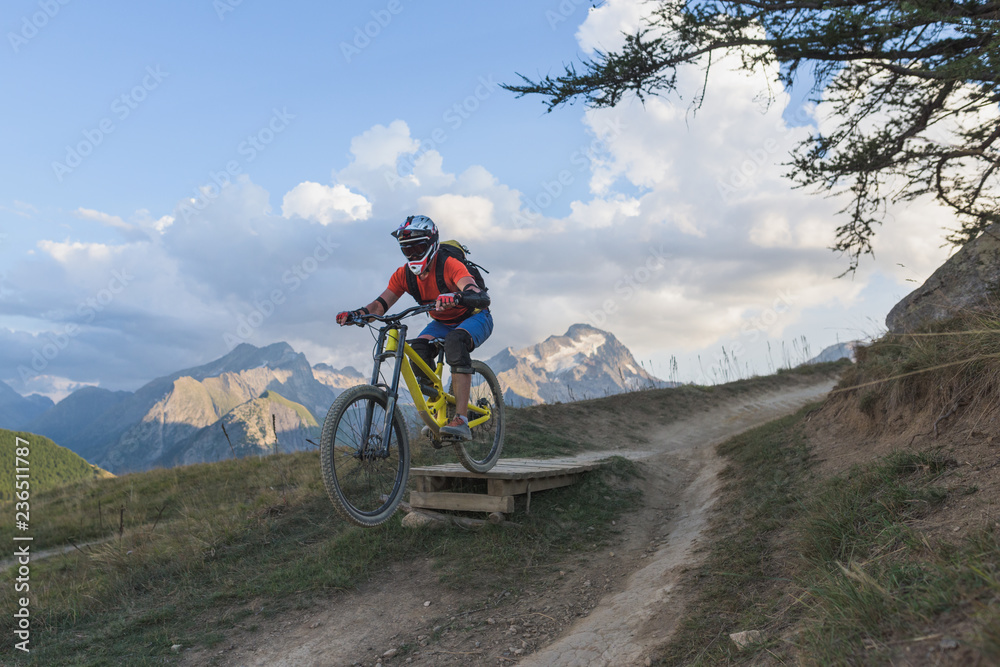 Man with mountain bike jumping off ramp Man with mountain bike jumping off ramp