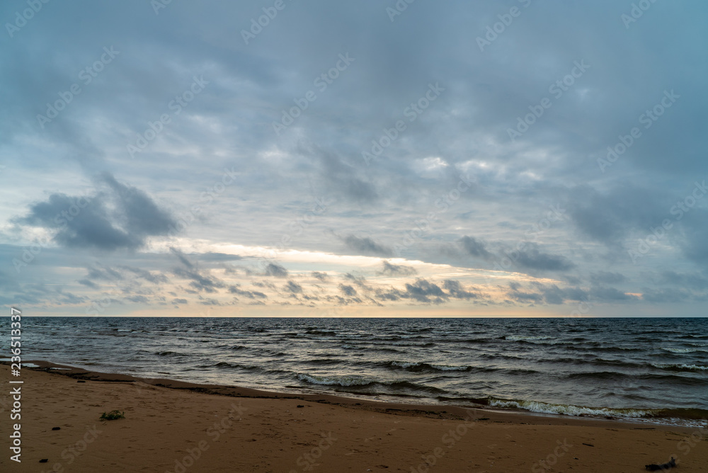 storm clouds forming over clear sea beach with rocks and clear sand storm clouds forming over clear sea beach with rocks and clear sand