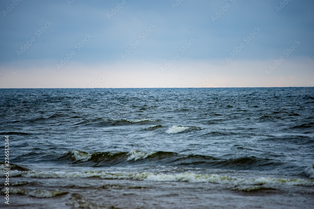 storm clouds forming over clear sea beach with rocks and clear sand storm clouds forming over clear sea beach with rocks and clear sand