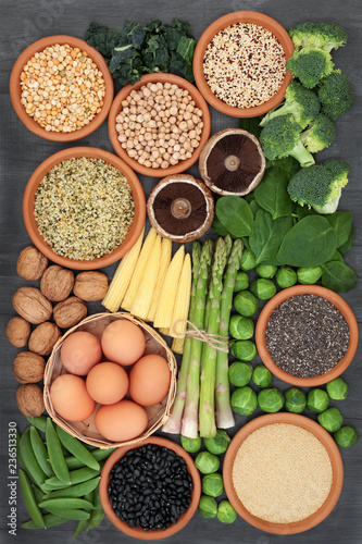 Healthy high protein food with fresh vegetables  legumes  dairy  grains  seeds and nuts. Super foods high in dietary fibre  vitamins and antioxidants. Top view.