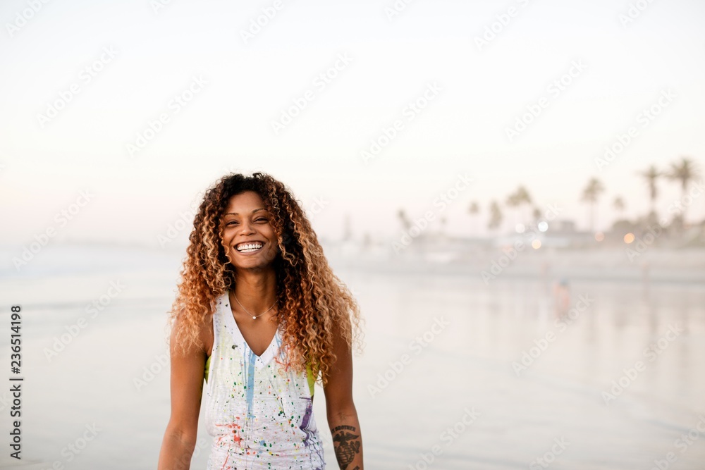Fit, stylish woman enjoying sunset walk in ocean water Fit, stylish woman enjoying sunset walk in ocean water