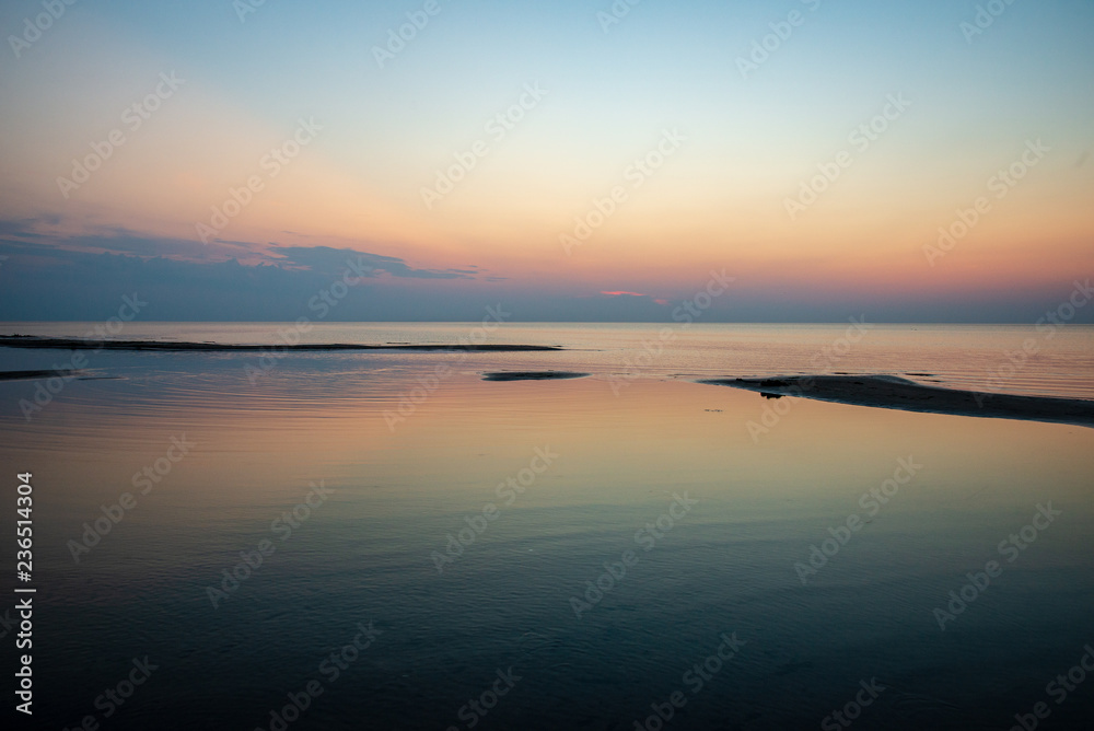Obraz premium calm blue sunset over clear water in baltic sea