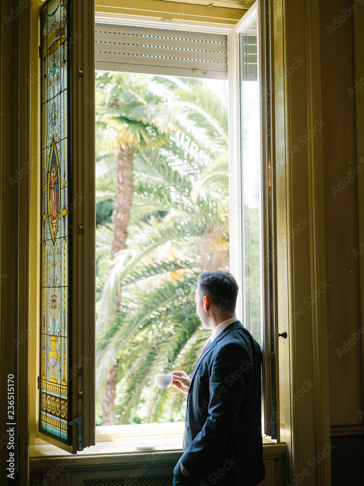 Anonymous elegant man in window Anonymous elegant man in window