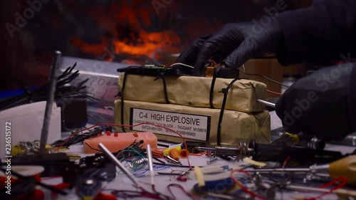 STYLIZED SHOT OF TERRORIST'S HANDS INSERTING BLASTING CAP INTO HIGH EXPLOSIVES.  4K SLIDER SHOT.