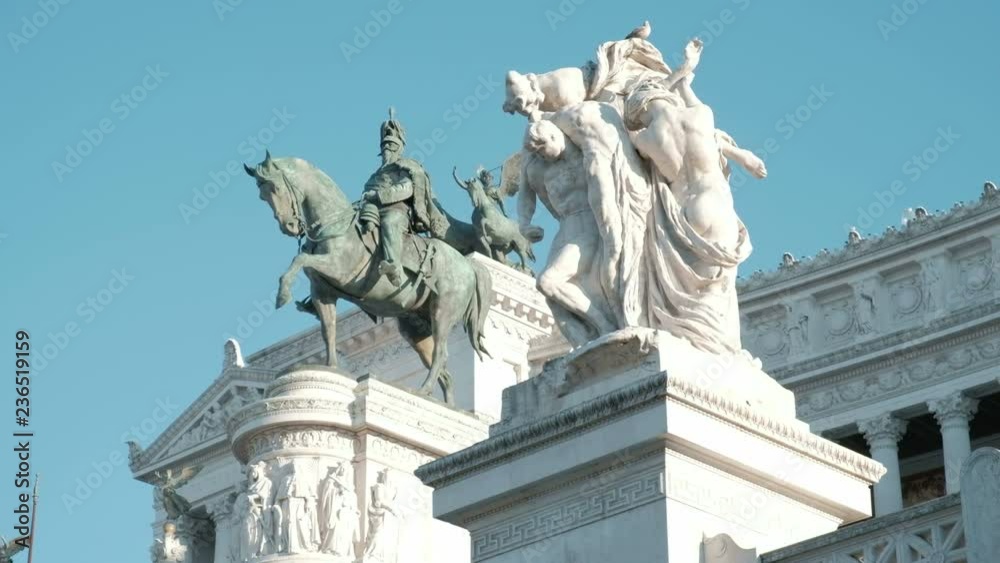 Detailed low angle close up view of statues in front of Il Vittoriano, or Altar of the Fatherland, steps on a sunny day in Rome, Italy. 4K UHD at 25fps Detailed low angle close up view of statues in front of Il Vittoriano, or Altar of the Fatherland, steps on a sunny day in Rome, Italy. 4K UHD at 25fps