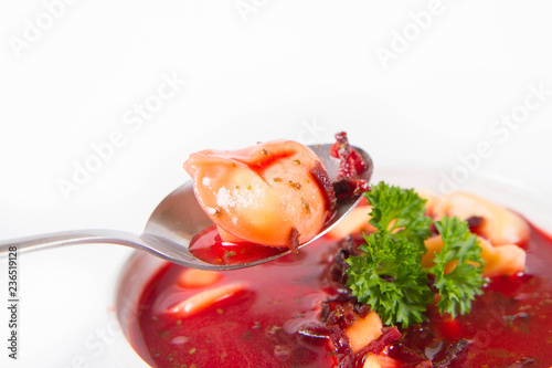 Traditional polish Christmas Eve dish: red borscht with uszko (a mushroom filled kind of dumpling) decorated with parsley eaten with a spoon
