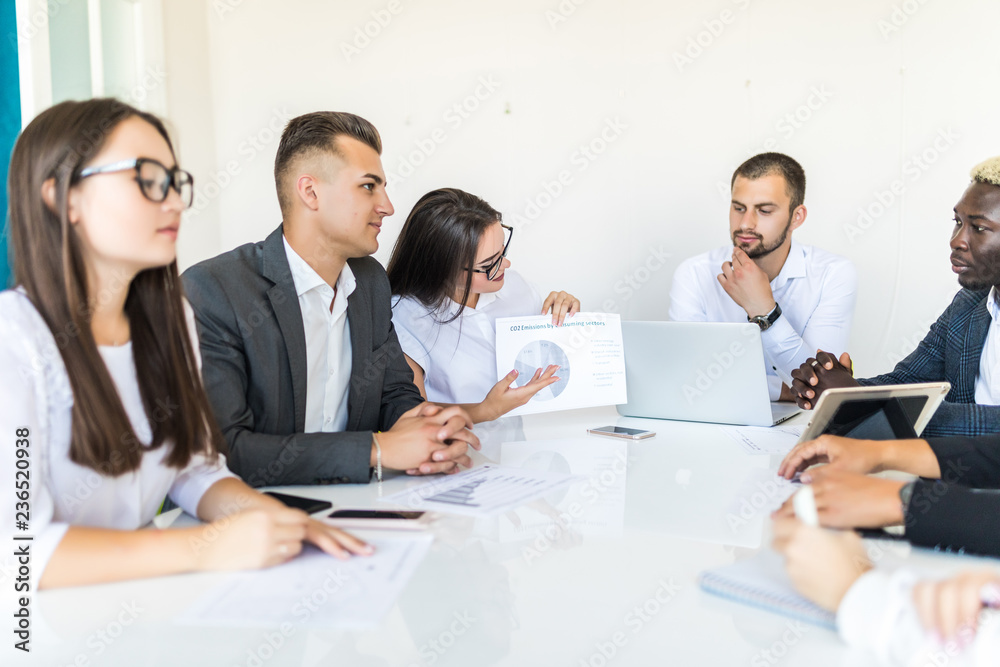 Handshake in diversity business team meeting, documents and graphs on the desk. Project meeting. Handshake in diversity business team meeting, documents and graphs on the desk. Project meeting.