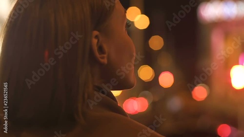 Attractive brunette lady looking at night city lights, megalopolis illumination