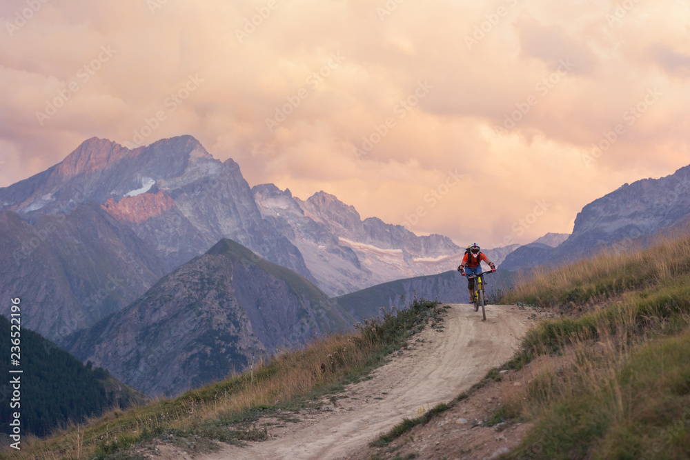 Man mountain biking downhill backcountry dirt trail