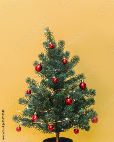 Small Christmas tree with baubles and lights photo