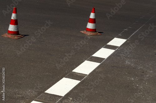 workers of city services drawing road marking