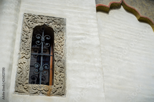 An ornate window at the Eastern Orthodox Stavropoleos Church in the old city area of Bucharest, Romania photo