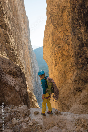 Female rock climber preparing to escalade steep rock wall