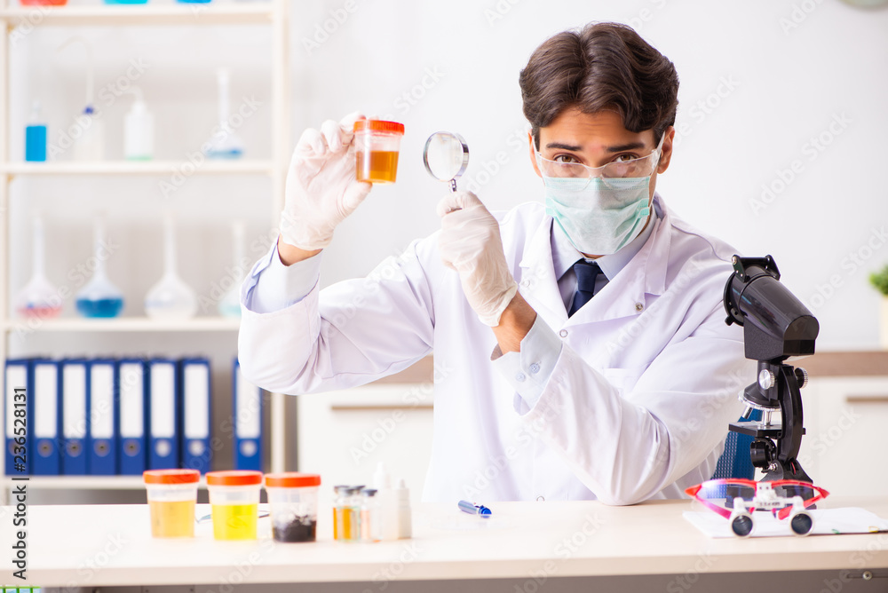 Young handsome chemist working in the lab Young handsome chemist working in the lab